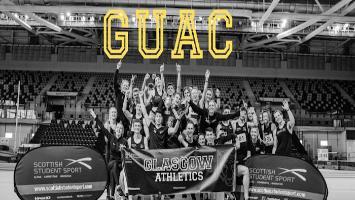 Black and white image of Glasgow University Athletics team behind banner. A group of around 30 celebrating. Banner reads Scottish Student Sport on each side and Glasgow Athletics in the middle. Yellow letter GUAC laid over the top of the image.