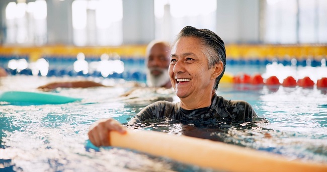 Older men exercising together in a swimming pool