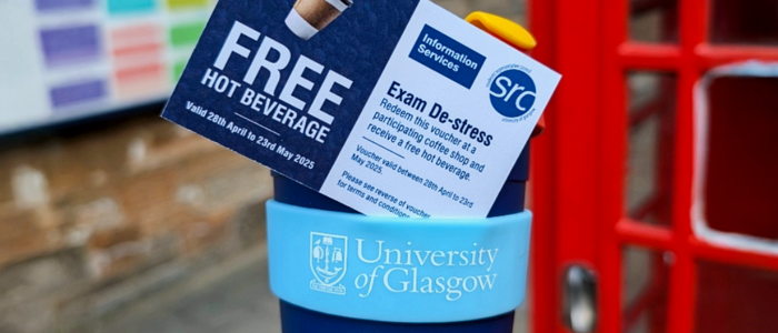 A hot drink voucher sitting in an empty UofG Coffee Cup