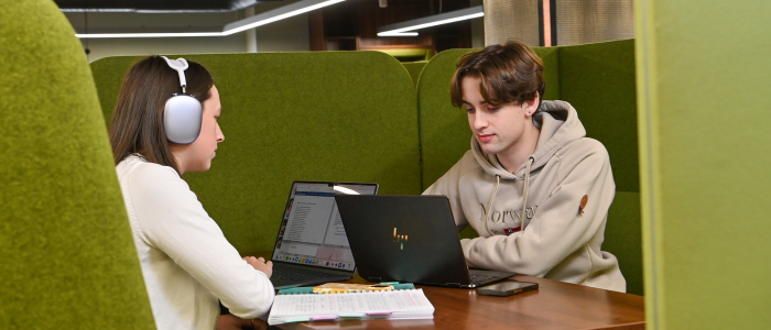 Two students studying in a pod in the JMS