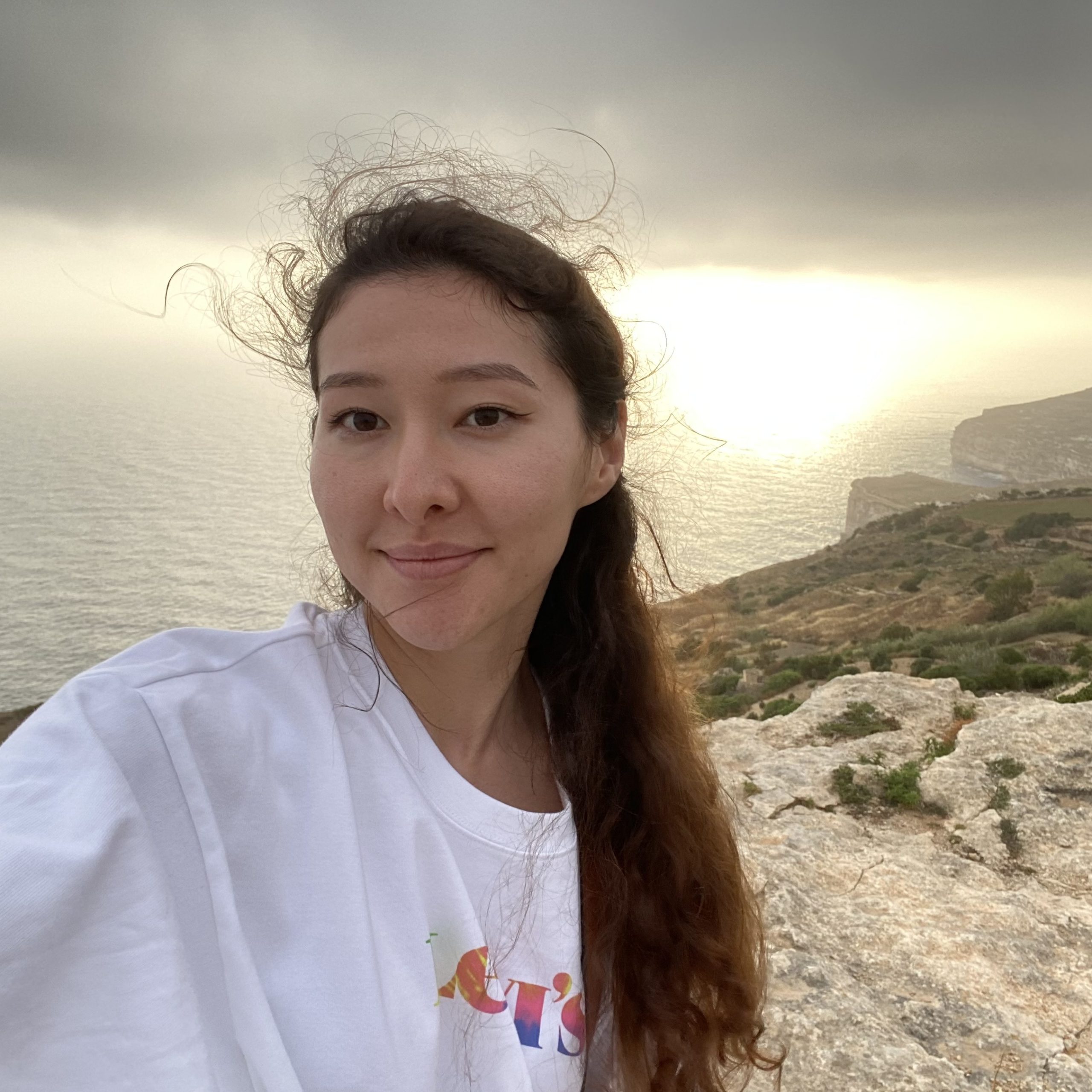 A student at the cliff at sunset