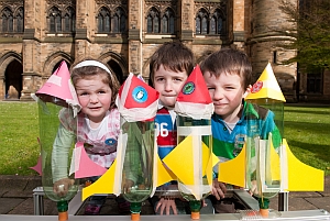 Siblings Ella (2), Tom (6), and Paul McHugh (4) of Clarkston prepare to launch their bottle rockets to mark the start of the Glasgow University Science Festival.