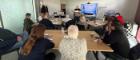 A group of people attending a writing workshop in Clarice Pears building.