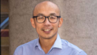 Professor Gwo-tzer Ho portrait shot, stood outside a building