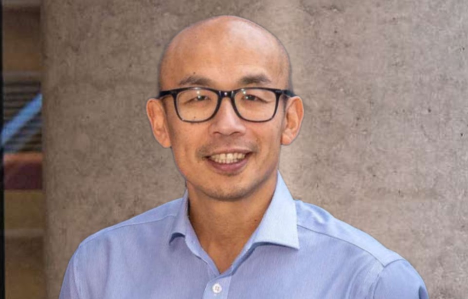 Professor Gwo-tzer Ho portrait shot, stood outside a building