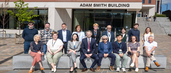 People sitting outside the Adam Smith Business School