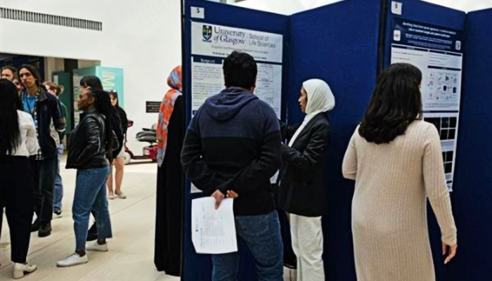 Staff and students peruse the poster boards on display at the Sii PGR Poster Day 2025