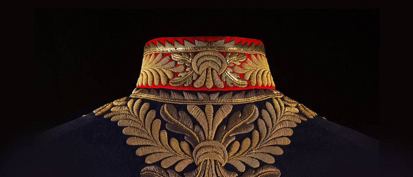 An ornate gold and red collar of a jacket