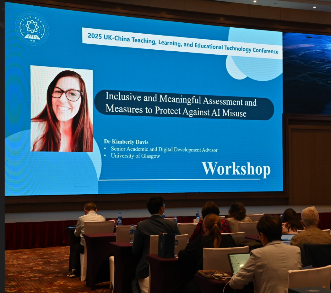 Am image of Dr Kimberly Davis slide on the main screen at the TILE TEC conference.