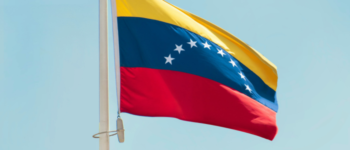Venezuelan flag flying against a blue sky