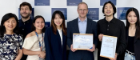 Winners of the ZIBS Global Corporate Consulting Project 2025 standing for a group photograph with their certificate beside three Adam Smith Business School academic staff
