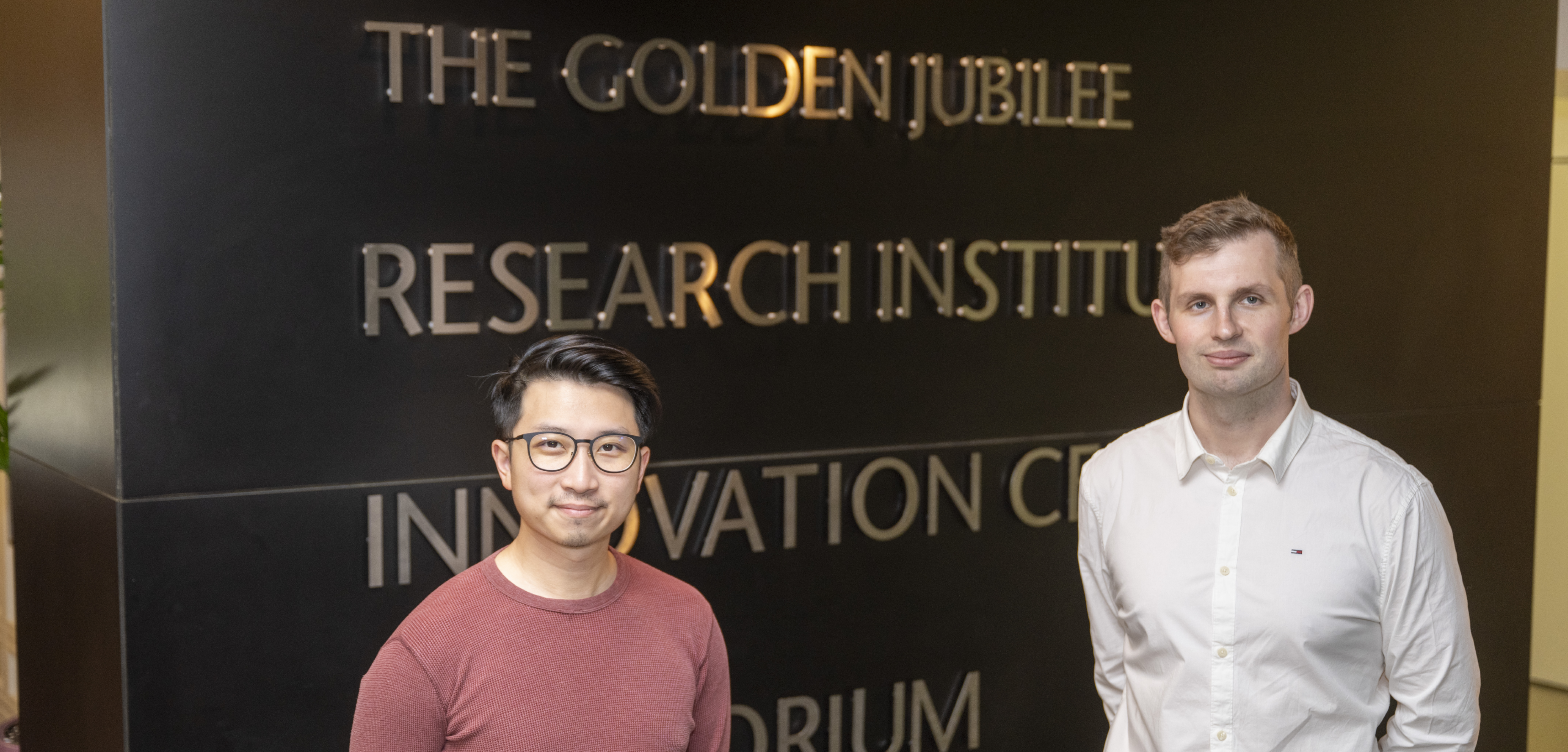 2 scientists in front of a building
