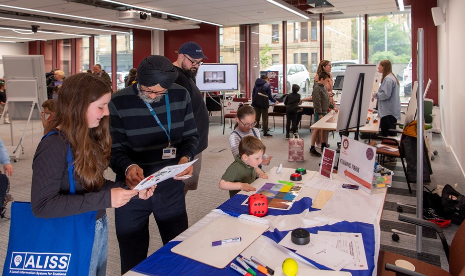 Adults and children taking part in a table-top escape room style activity