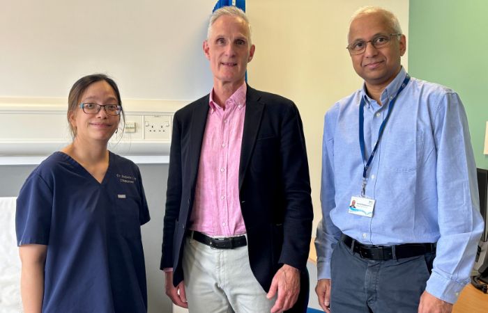 Two clinicians and a patient in a hospital setting