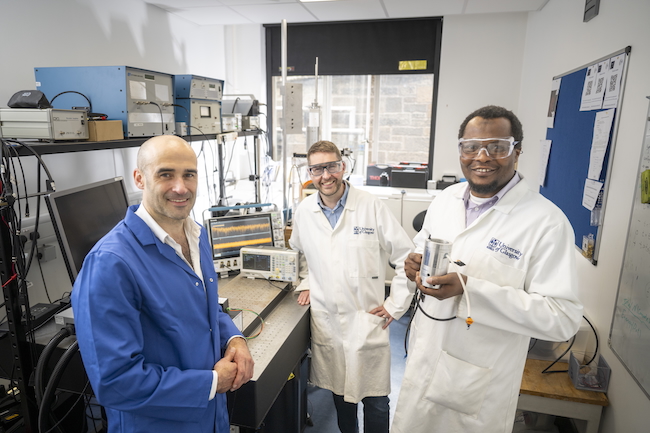Dr Paul Prentice, Professor Mark Symes, and Dr Lukman Yusuf of the University of Glasgow pose with the £20 prototype device they built to produce nitrate from water and air using ultrasound