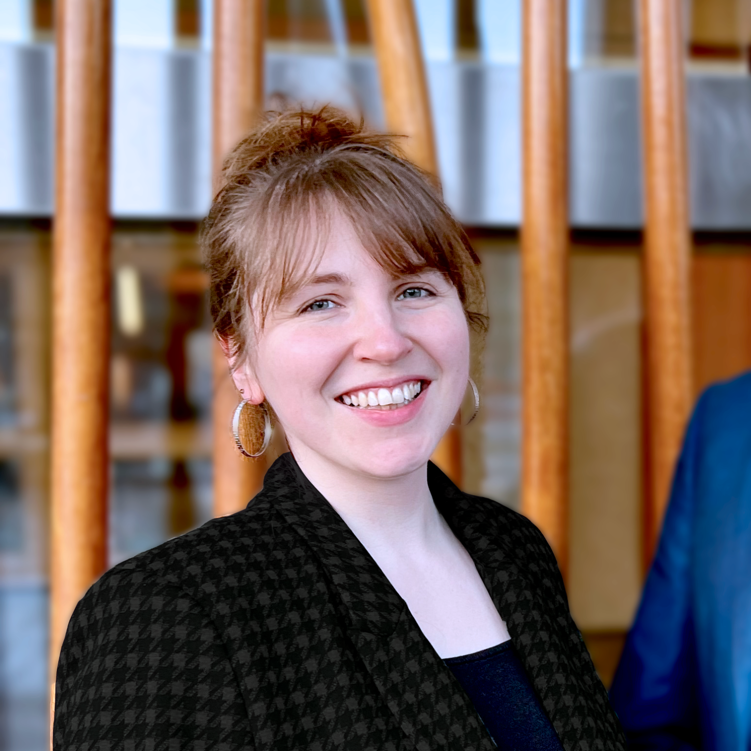 Dr Elisabeth Loose, a white woman with brown hair, put up in a bun, wearing a black blazer.