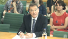 Professor Donal Wall sat at a desk in front of the House of Commons committee, sharing his oral evidence