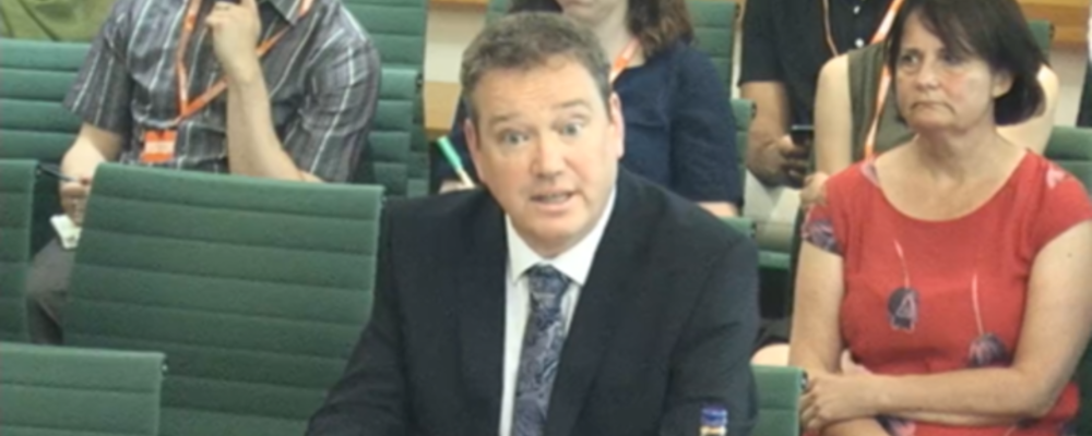Professor Donal Wall sat at a desk in front of the House of Commons committee, sharing his oral evidence
