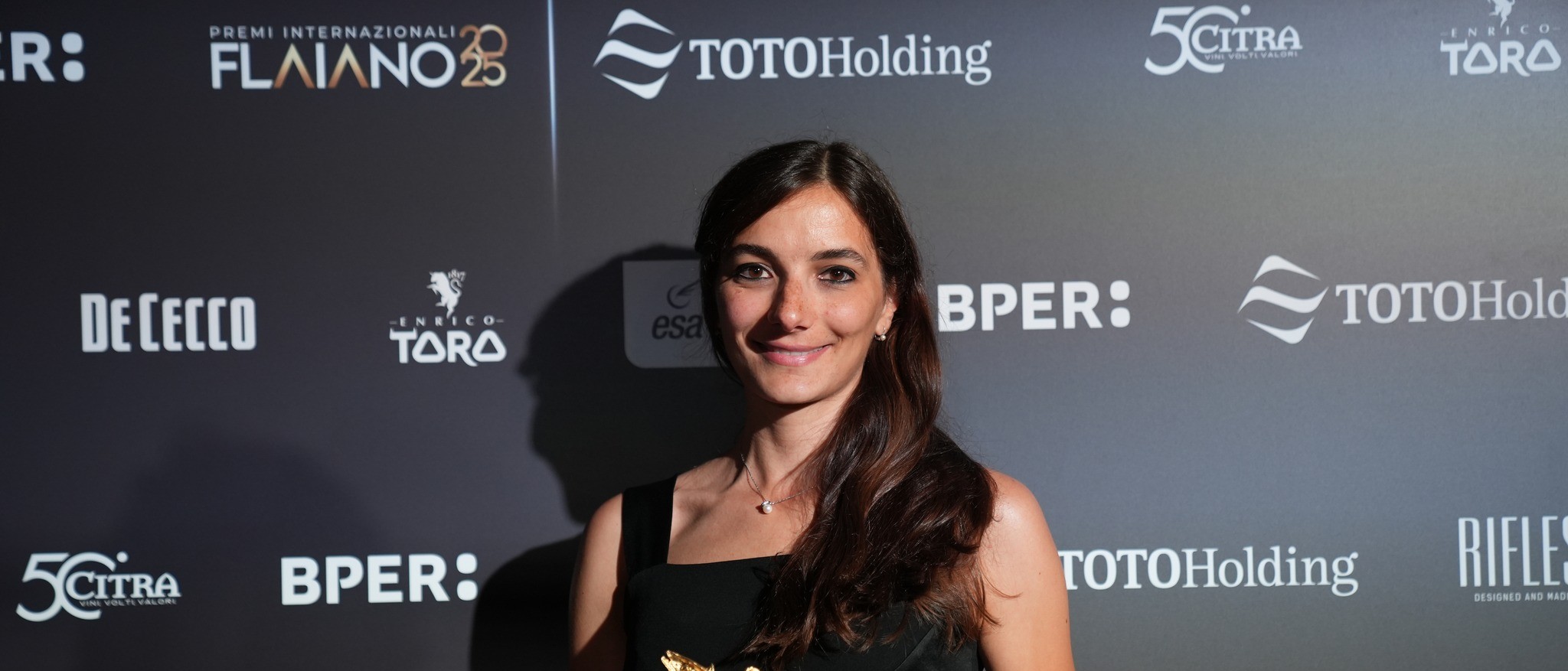 Claudia Dellacasa holding an award
