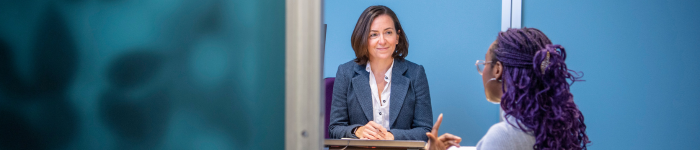 Student facing an advisor across a desk