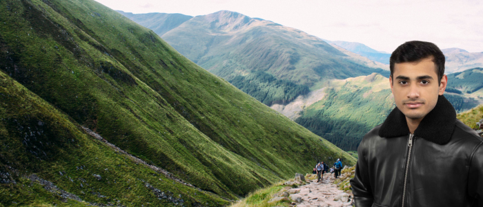 view through Glen Nevis on the climb up Ben Nevis with headshot of Shadab on the right-hand side of the image