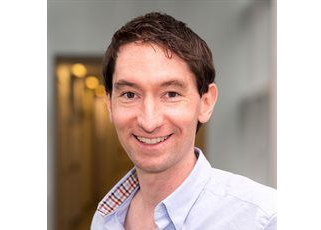 A head and shoulders portrait shot of Dr Chris Mahony