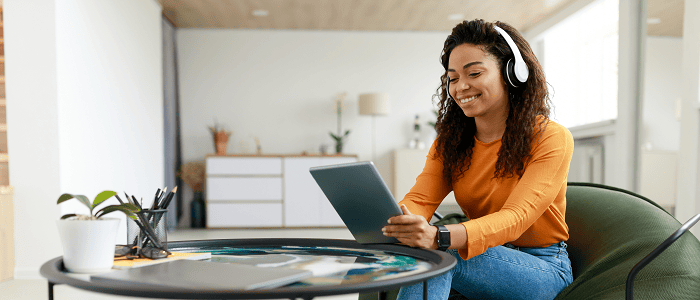 Woman reading tablet while sitting beside a coffee table