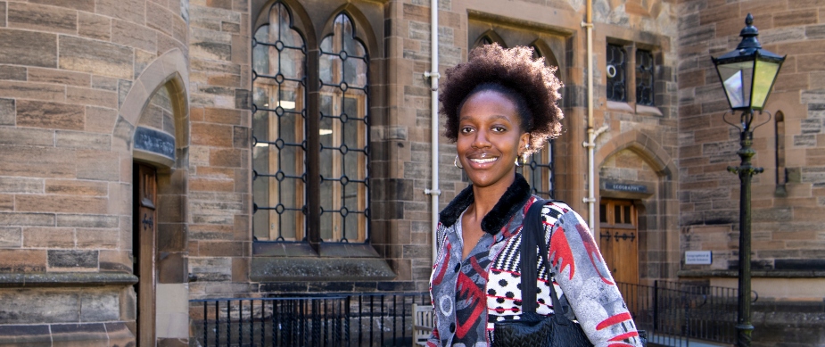 A student in the Quadrangles of the Gilbert Scott Building
