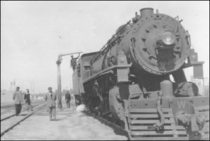A photograph of the water crane in use, built for the Iraqi State Railways by Glenfield & Kennedy Ltd.  (GUAS Ref: UGD 5/3/10/64/6.  Copyright reserved.)