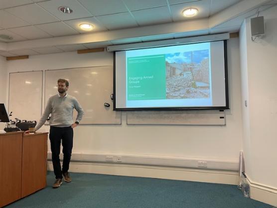 Dr Florian Weigand delivering a presentation on Engaging Armed Groups