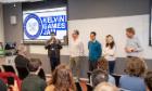A group of contestants standing in front of an audience at Kelvin Games Jam 2024