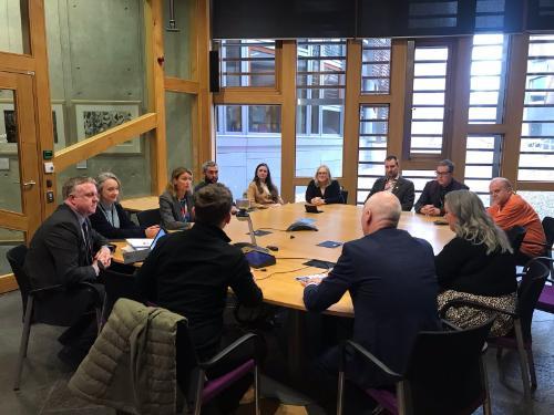 A round table event at the Scottish Parliament in November 2023 to coincide with the Dying in the Margins debate in the chamber and the Cost of Dying exhibition at the parliament. MSPs attended with members of the UofG research team, Marie Curie, and relatives of study participants.