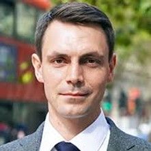 Portrait of a young man, with a London bus in the background