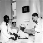 The perfect bedside manner of the Glasgow team at Kenyatta National Hospital, Kenya, 1966.  (GUAS Ref:  DC 119.  Copyright reserved.)