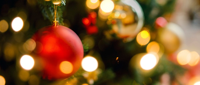 Red and silver Christmas tree decorations with blurred lights
