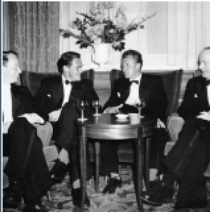 Image of Prof Bill Jarrett and vet med colleagues in black tie at an event in the 60s sitting around a table having drinks