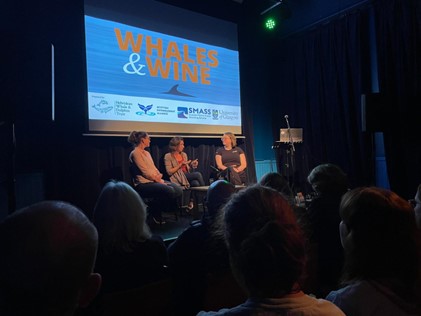 3 researchers holding discussion on stage