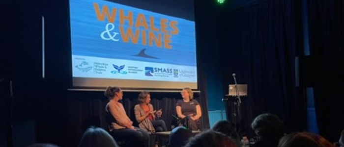 3 researchers holding discussion on stage