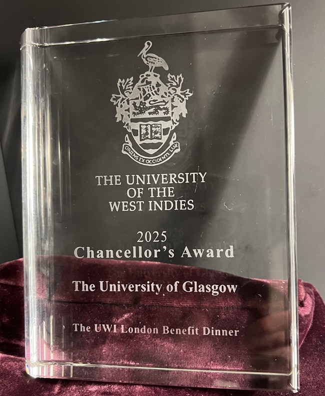 A photo of a glass trophy for the University of the West Indies Chancellor's Award