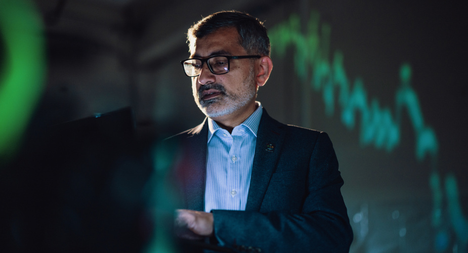 Professor Muhammad Ali Imran in a lab environment looking at a computer screen