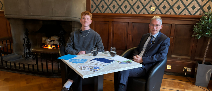 Duncan Calvert and Andy Schofield sitting at a table smiling at the camera