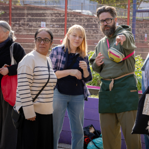 Members of the project team standing together while one of them points at something towards the camera but out of frame.