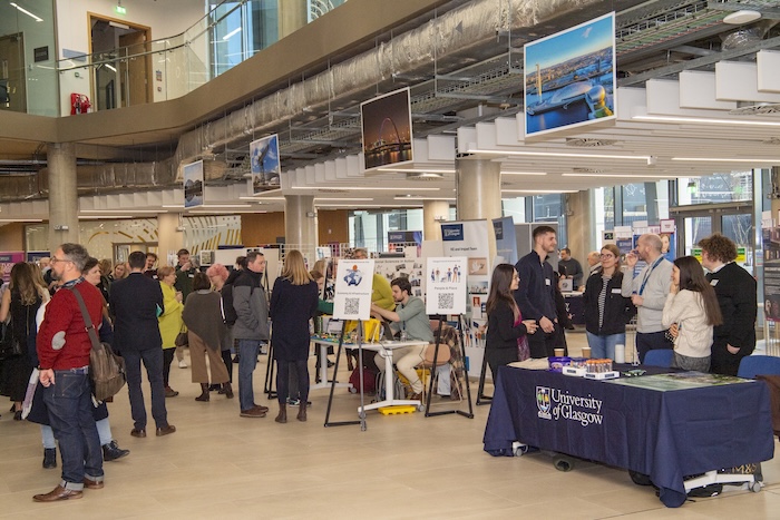 Image of the previous awards event featuring attendees networking and displaying their posters
