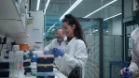 Researcher and staff member shown working at a station in a Keltic Pharma laboratory setting