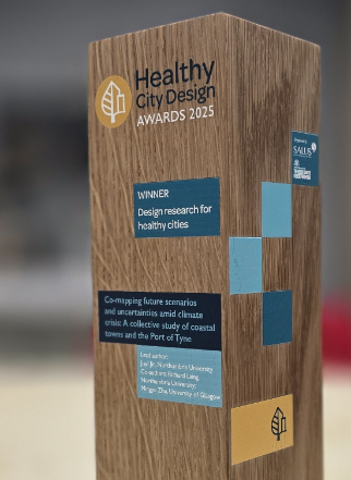 Wooden award with the category, paper title, and authors