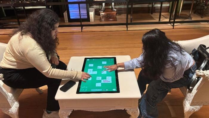 Students playing on a digital and interactive screen