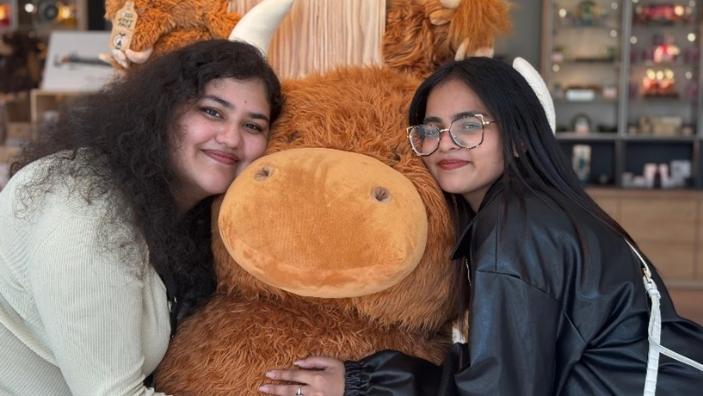 Students with highland cow plush toy