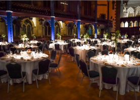 Image of the Bute Hall set out with dinner tables set for evening event