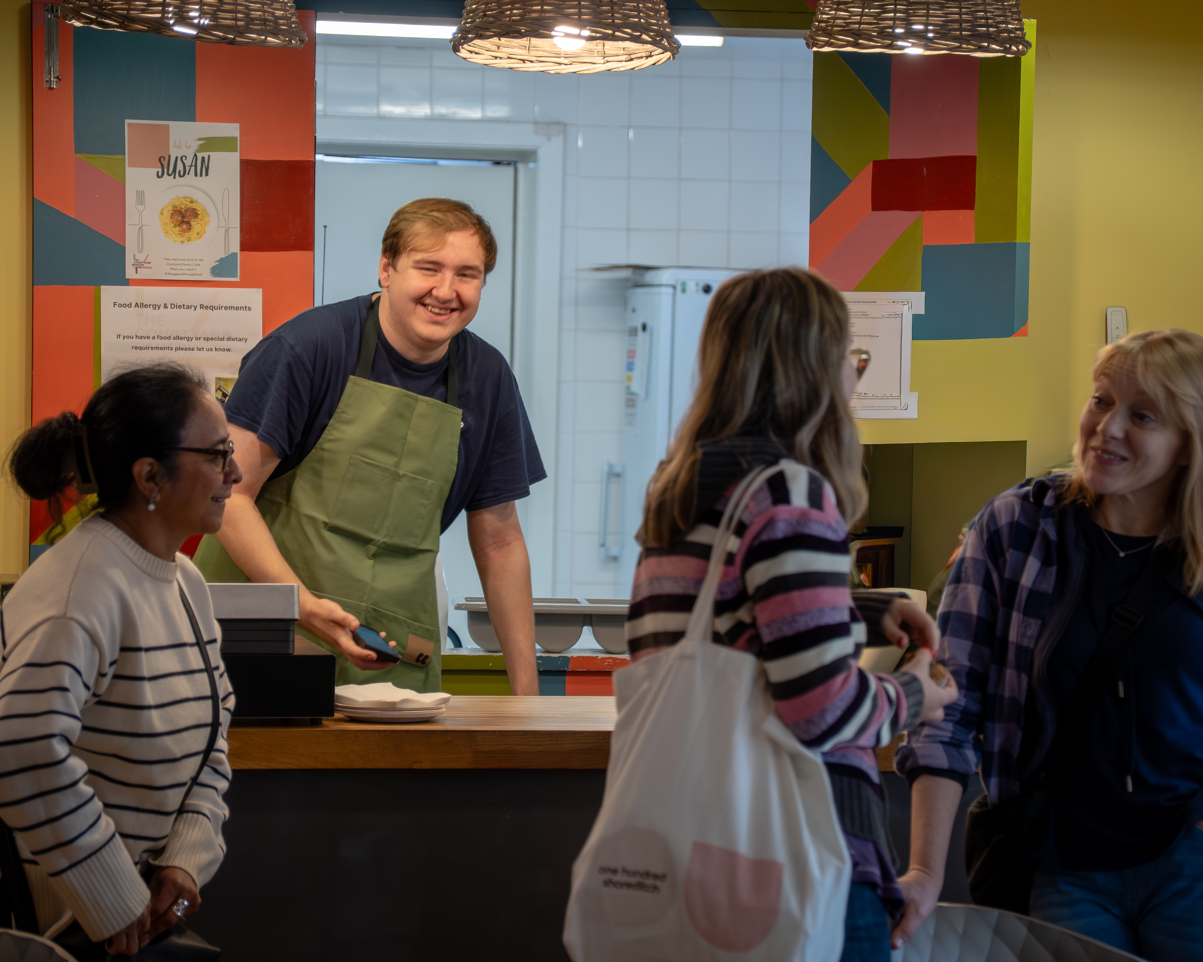 barista laughing with customers