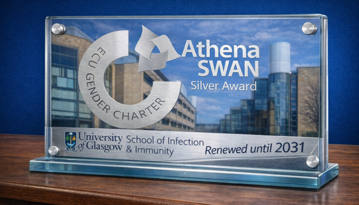 A graphic with a glass plaque sat on a wooden table, with the SGDB in the background, the Athena Swan logo on the glass, and a silver strip with the Sii logo and 'renewed until 2031' in text